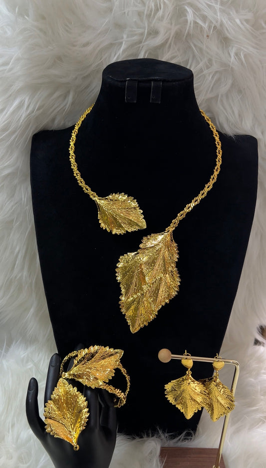 Gold leaf necklace, earrings, and ring set. Perfect for modern brides, high-fashion galas, or milestone celebrations, this set is a wearable work of art.