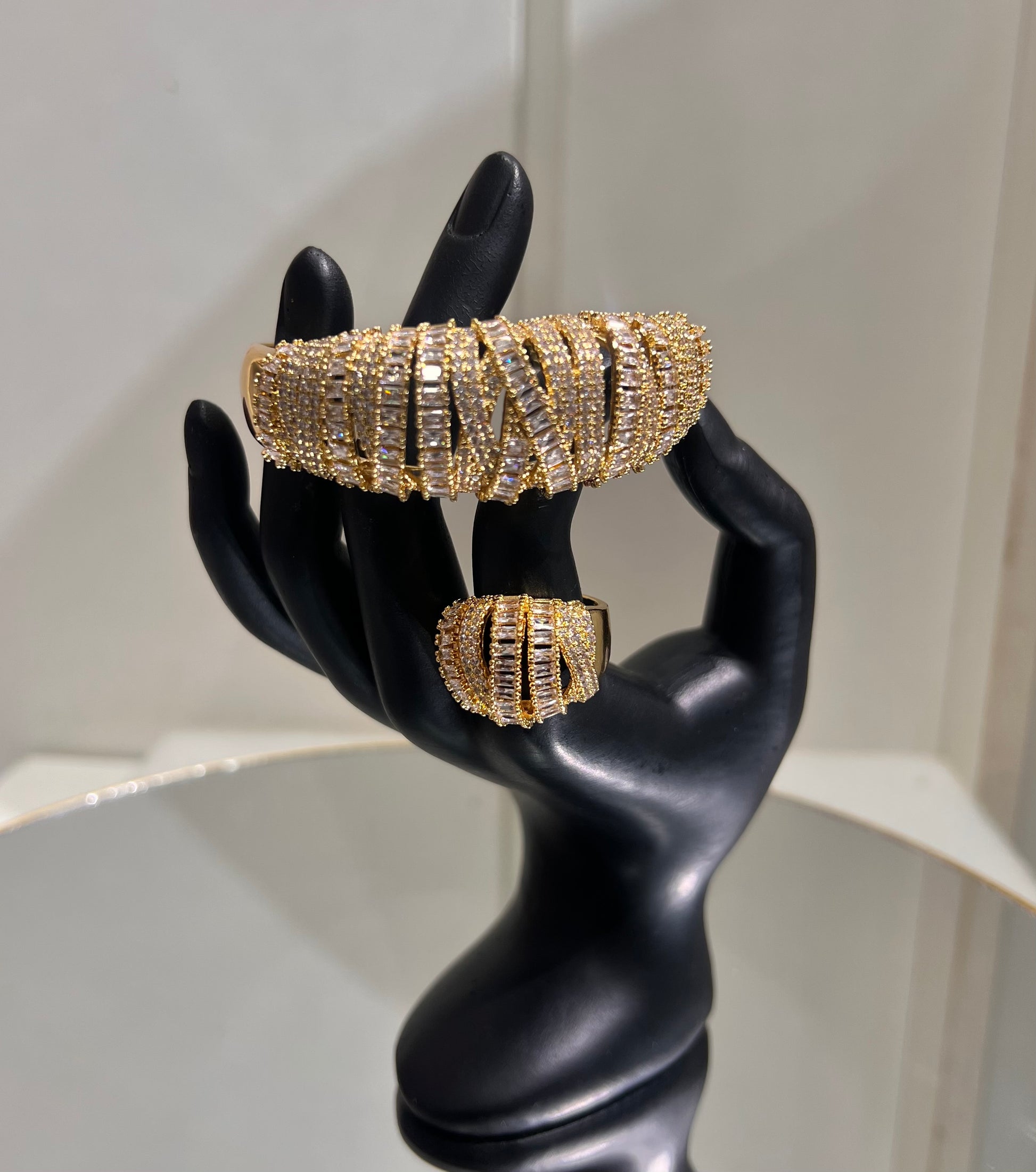 The result is a highly structured, dimensional design that catches the light continuously, offering a high-glamour look perfect for red carpets, galas, or bridal statement wear.