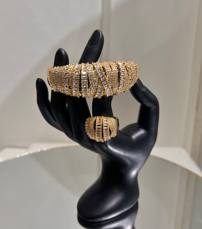 The result is a highly structured, dimensional design that catches the light continuously, offering a high-glamour look perfect for red carpets, galas, or bridal statement wear.