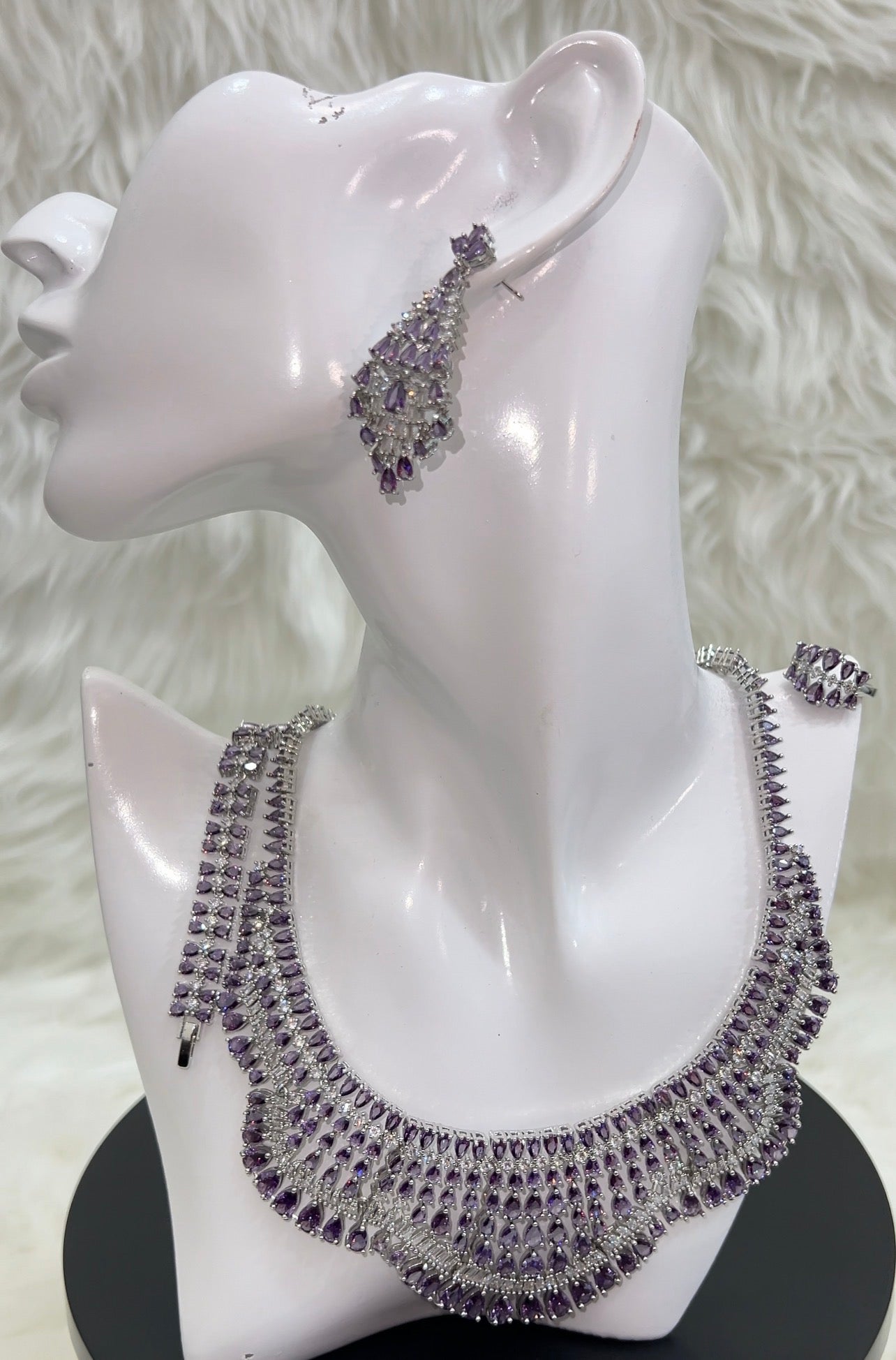 A bold, multi-layered collar design that elegantly frames the neckline, securing with a durable and seamless clasp.