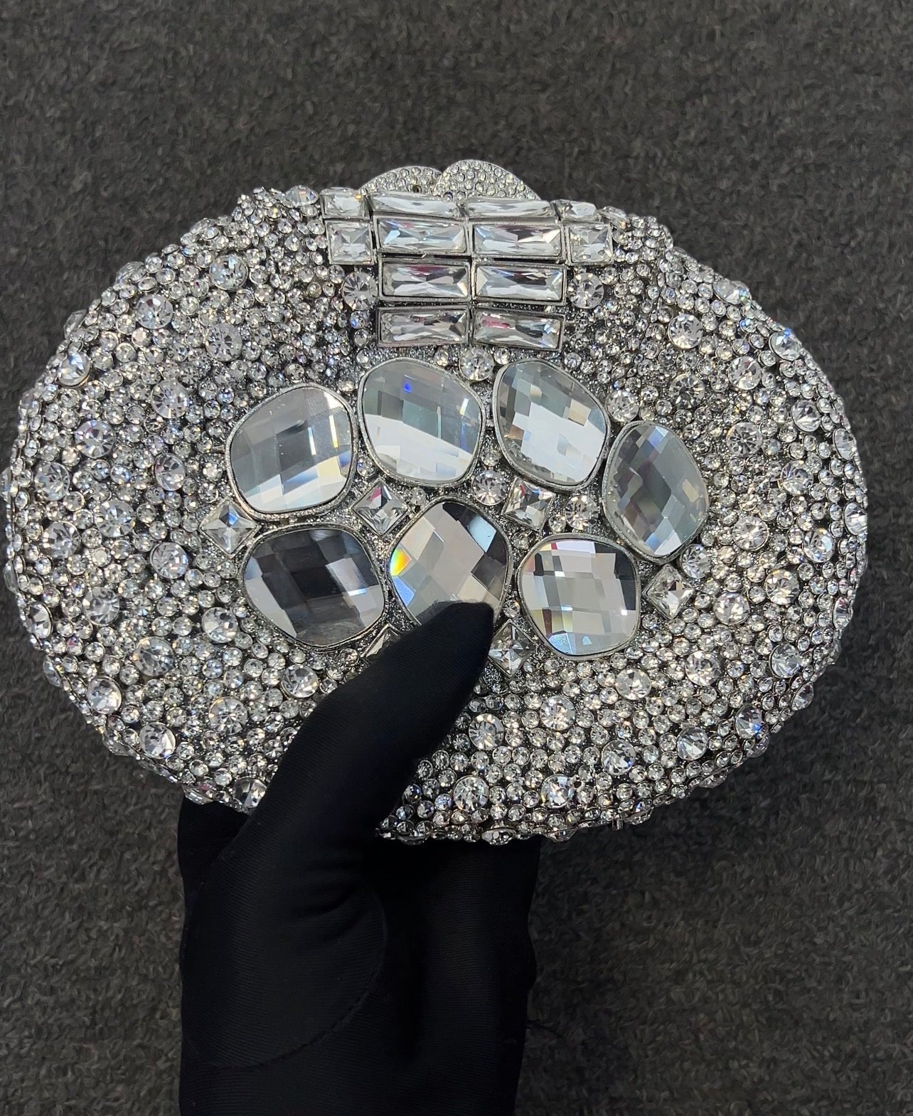 Designed for the modern bride, gala attendee, or high-fashion host, this hard-shell clutch securely protects your essentials while serving as a wearable piece of fine jewelry.