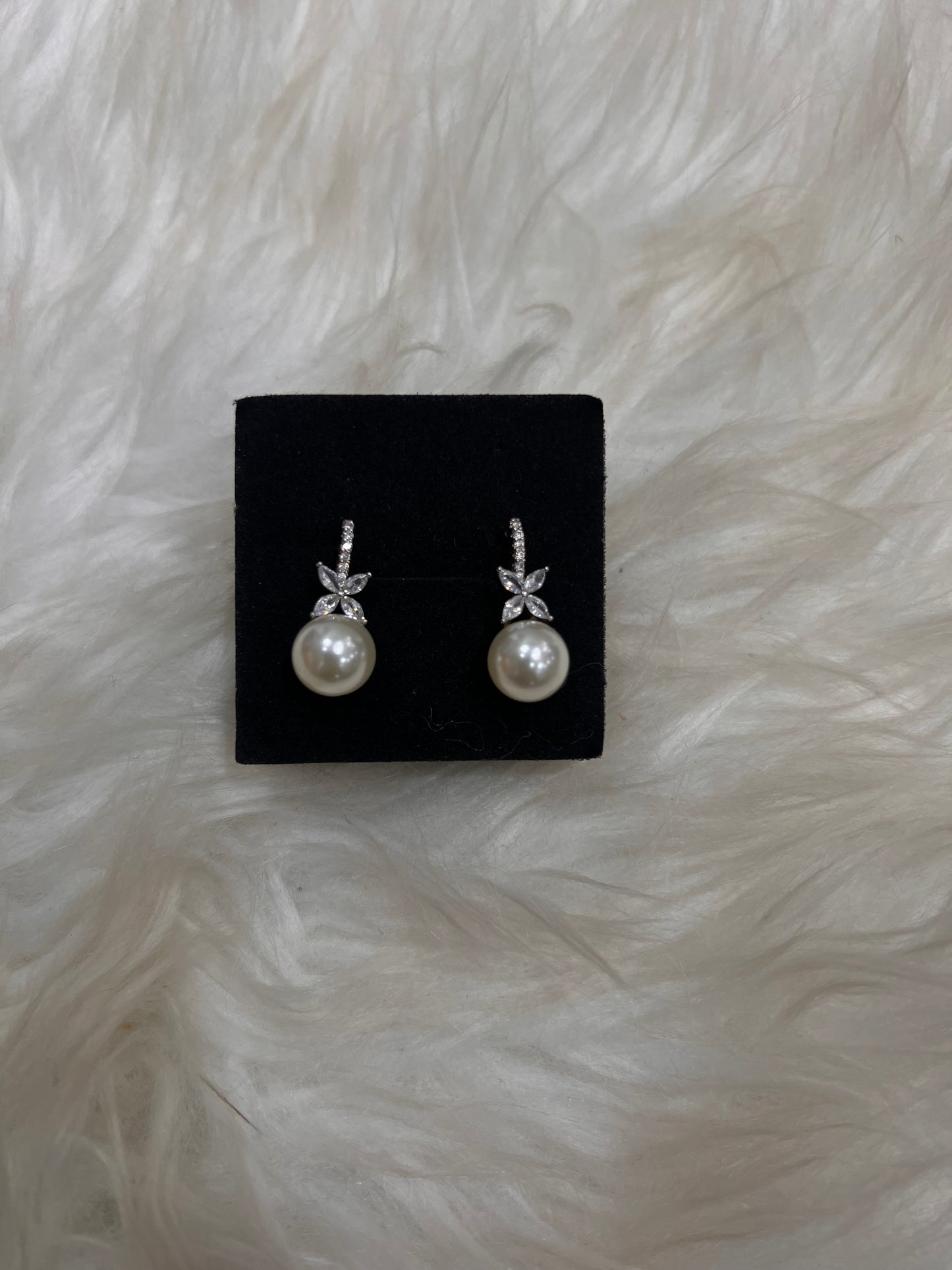 Pair of pearl earrings, these earrings add just the right amount of sparkle and sophisticated charm without overpowering your dress.