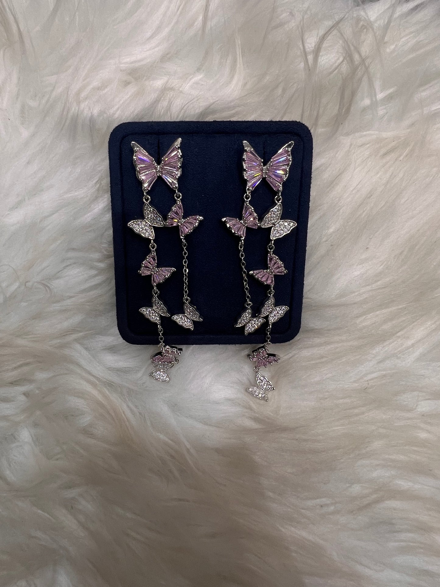 Butterfly-shaped earrings with pink gemstones. these pieces offer lightweight comfort, a smooth, snag-free finish, and maximum brilliance under the lights.