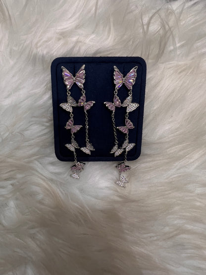 Butterfly-shaped earrings with pink gemstones. these pieces offer lightweight comfort, a smooth, snag-free finish, and maximum brilliance under the lights.