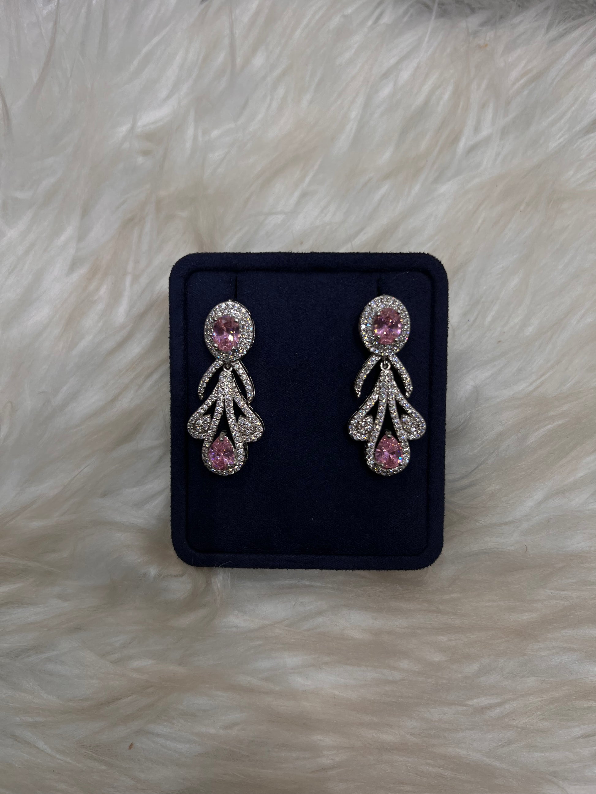 Pair of silver earrings with pink gemstones, Perfect for bridal party coordination or high-end formal wear.