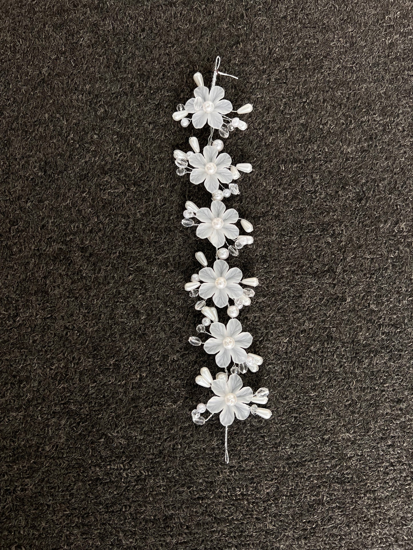 Perfect for the modern bride seeking romantic glamour, it features finished wire loops at each end to effortlessly pin into place for a comfortable, reliable fit throughout your celebration.