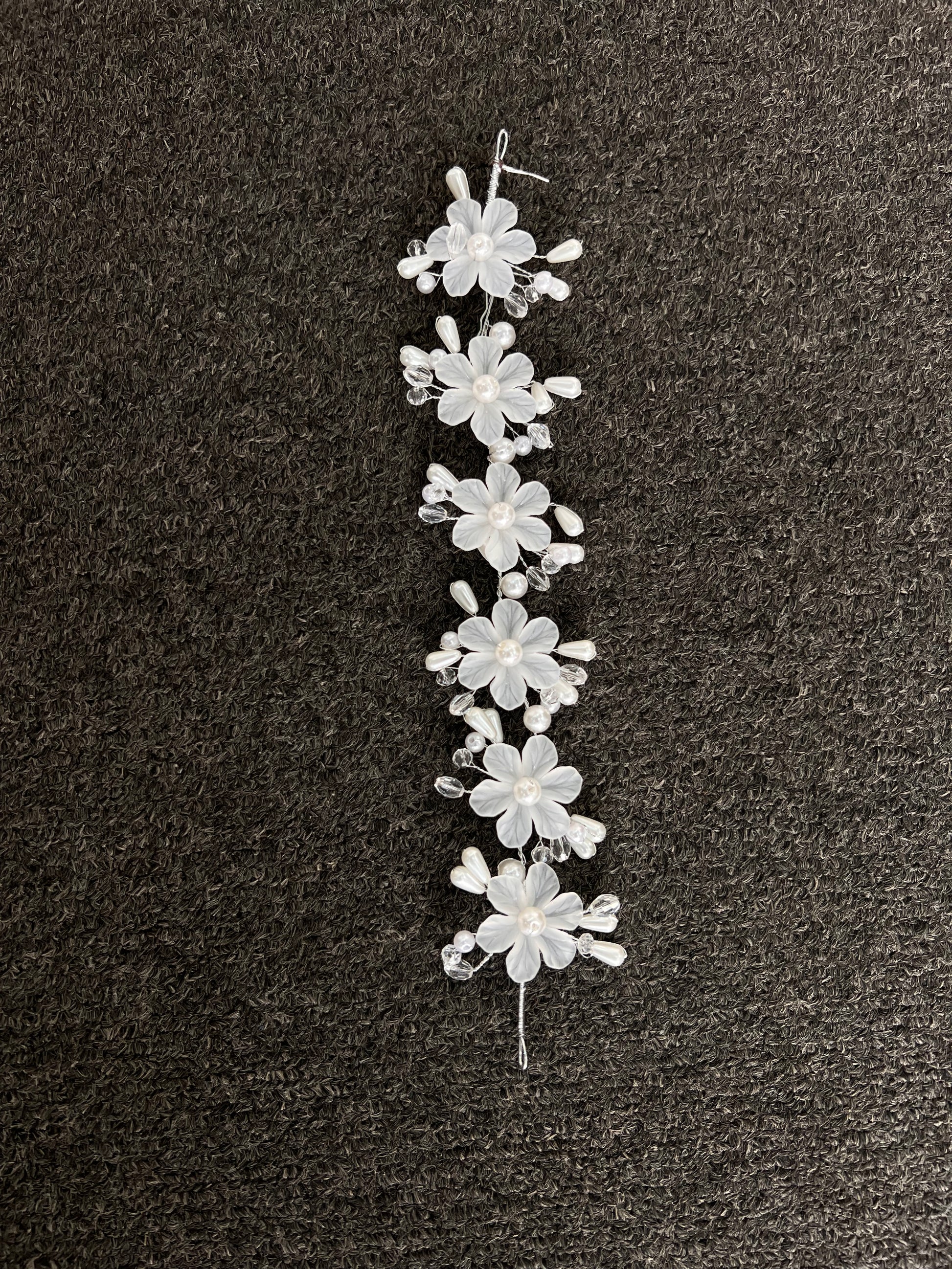 Perfect for the modern bride seeking romantic glamour, it features finished wire loops at each end to effortlessly pin into place for a comfortable, reliable fit throughout your celebration.