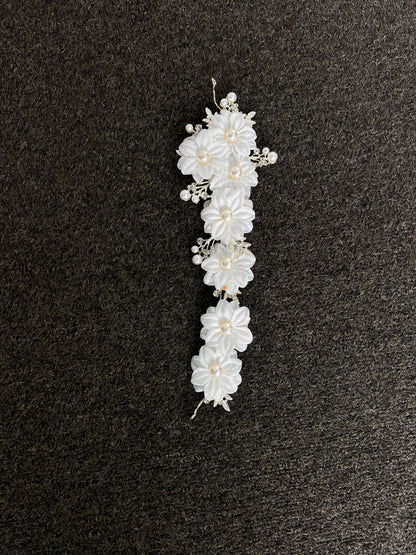 White floral hair accessory with pearls . Crafted with a premium, lightweight finish, it secures comfortably with bobby pins or ribbons for a luxurious, snag-free fit that lasts from the ceremony to the final dance.