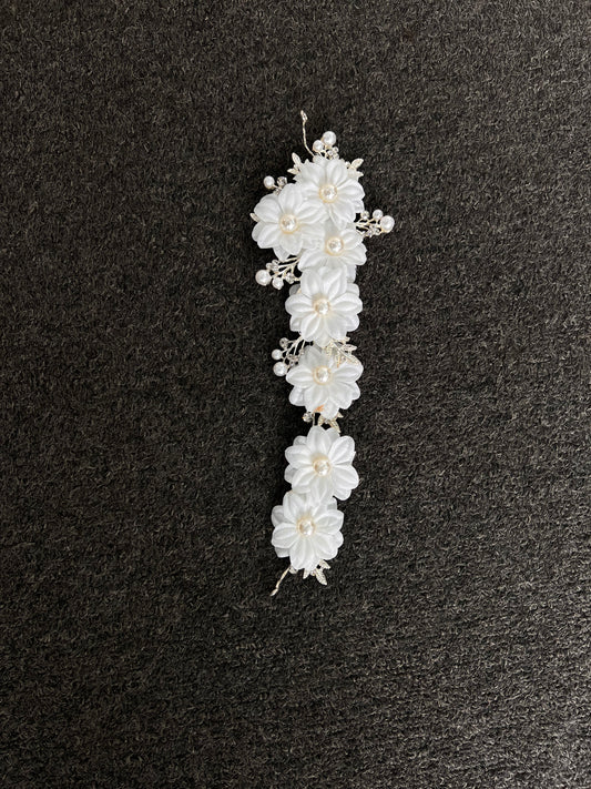 White floral hair accessory with pearls . Crafted with a premium, lightweight finish, it secures comfortably with bobby pins or ribbons for a luxurious, snag-free fit that lasts from the ceremony to the final dance.
