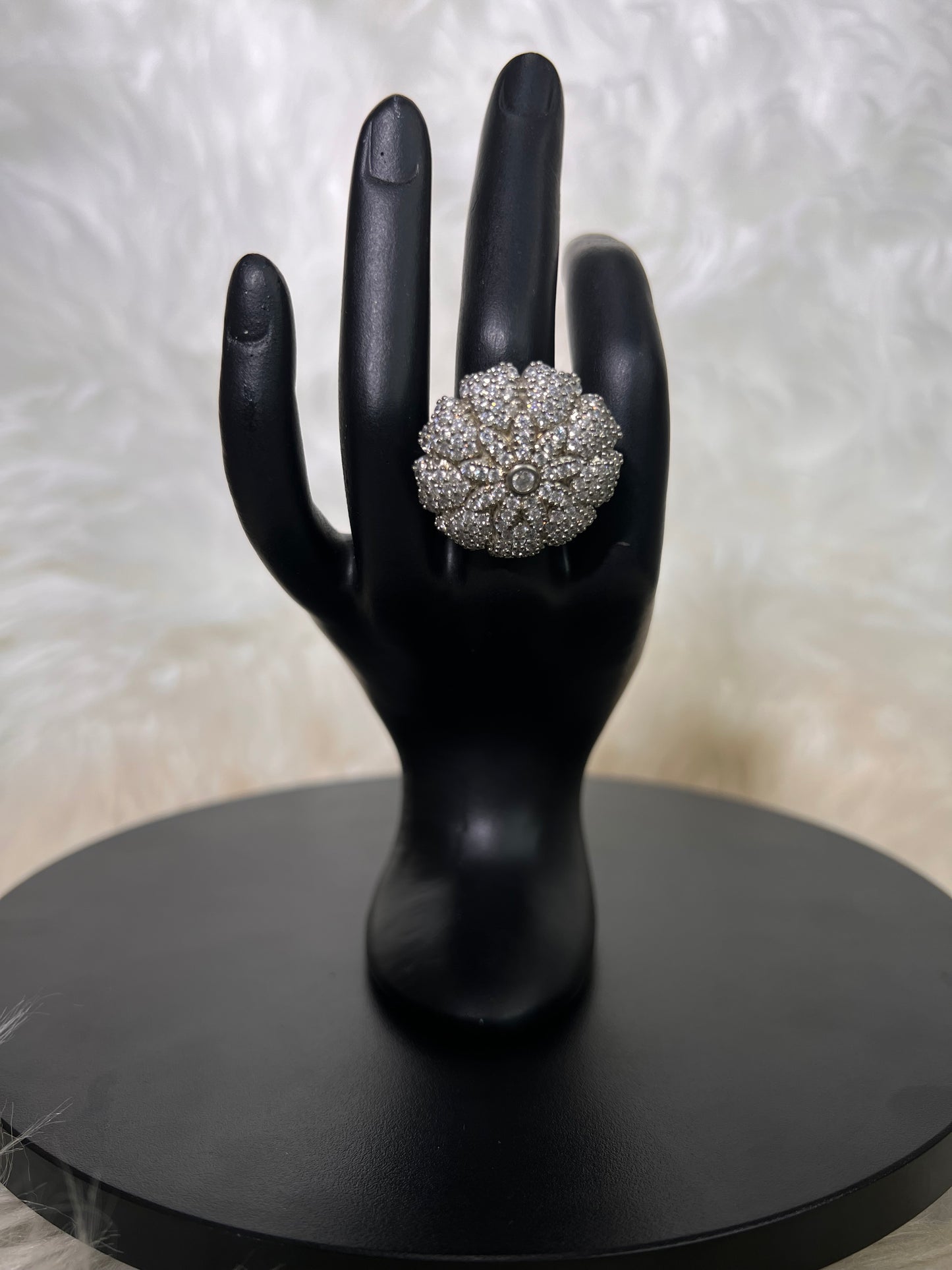 An oversized, domed cushion floral burst packed with dense, shimmering pave stones, radiating a bright, geometric sunflower silhouette.