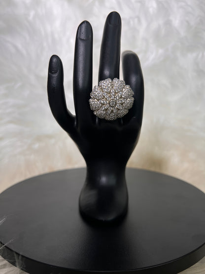An oversized, domed cushion floral burst packed with dense, shimmering pave stones, radiating a bright, geometric sunflower silhouette.