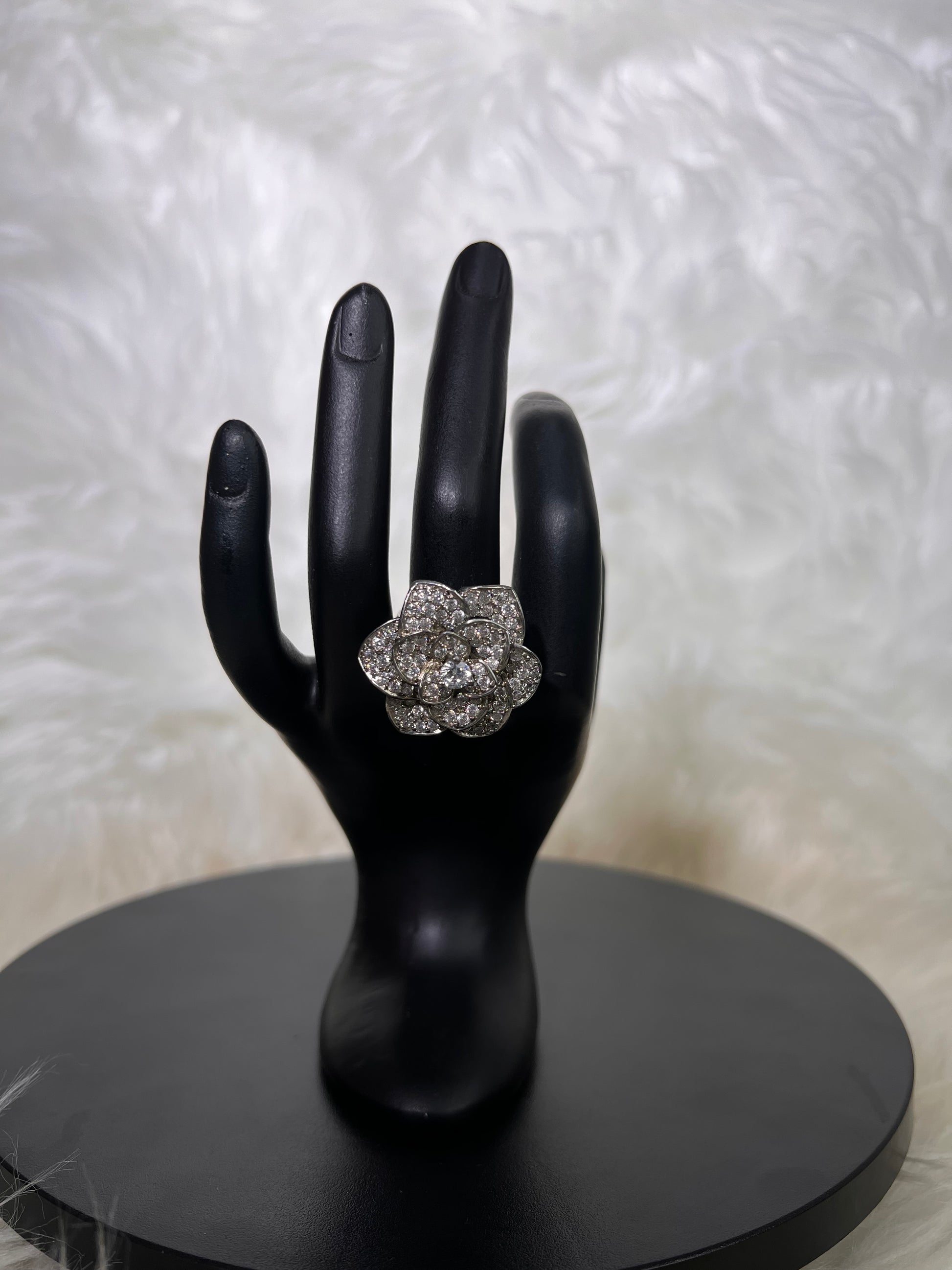 A magnificent silver-tone dimensional rose in full bloom, featuring individual layered petals completely encrusted with micro-pave cubic zirconia and a brilliant round center stone.