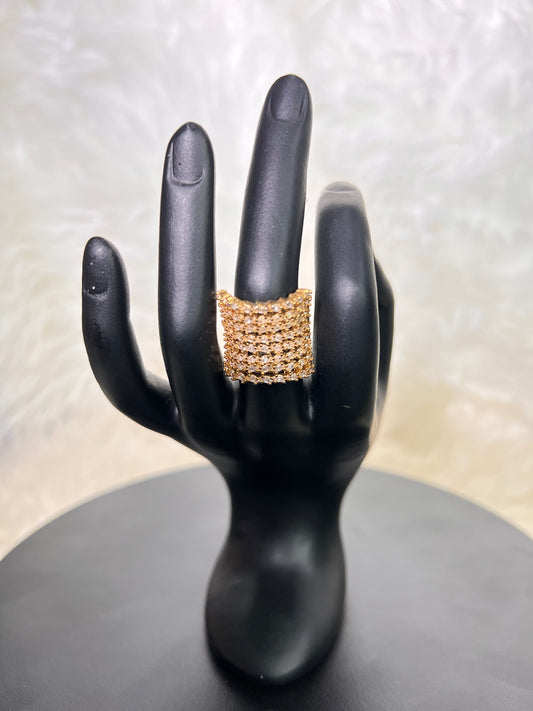 A bold, statement-making wide concave band featuring rows of brilliant micro-pave cubic zirconia. It offers a majestic, shield-like shimmer that catches light from every angle