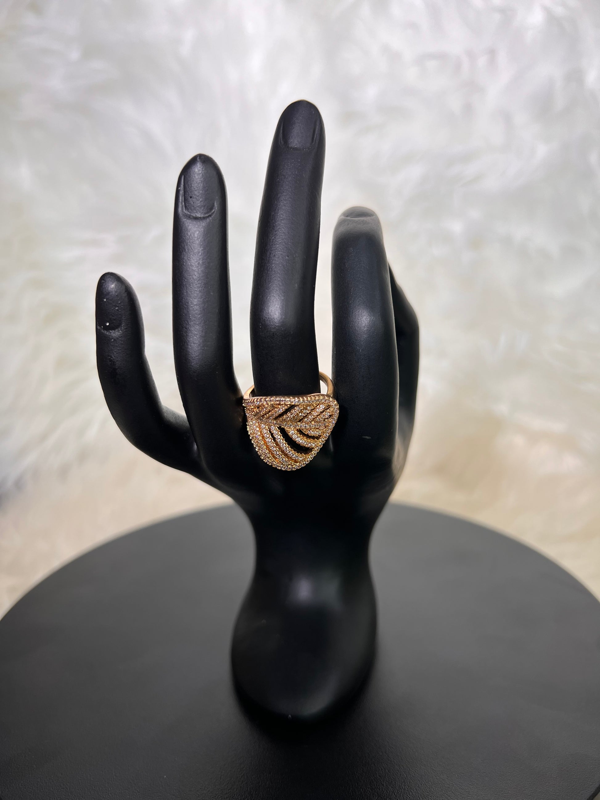 An elegant, open-work stylized leaf or fan design. Its sweeping, pave-set curved lines provide a sophisticated organic flair, beautifully balancing negative space with brilliant fire.