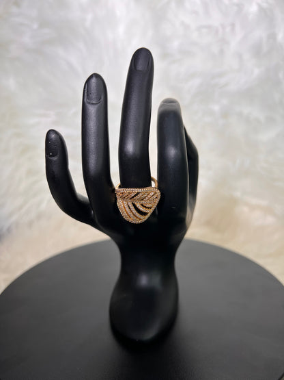 An elegant, open-work stylized leaf or fan design. Its sweeping, pave-set curved lines provide a sophisticated organic flair, beautifully balancing negative space with brilliant fire.