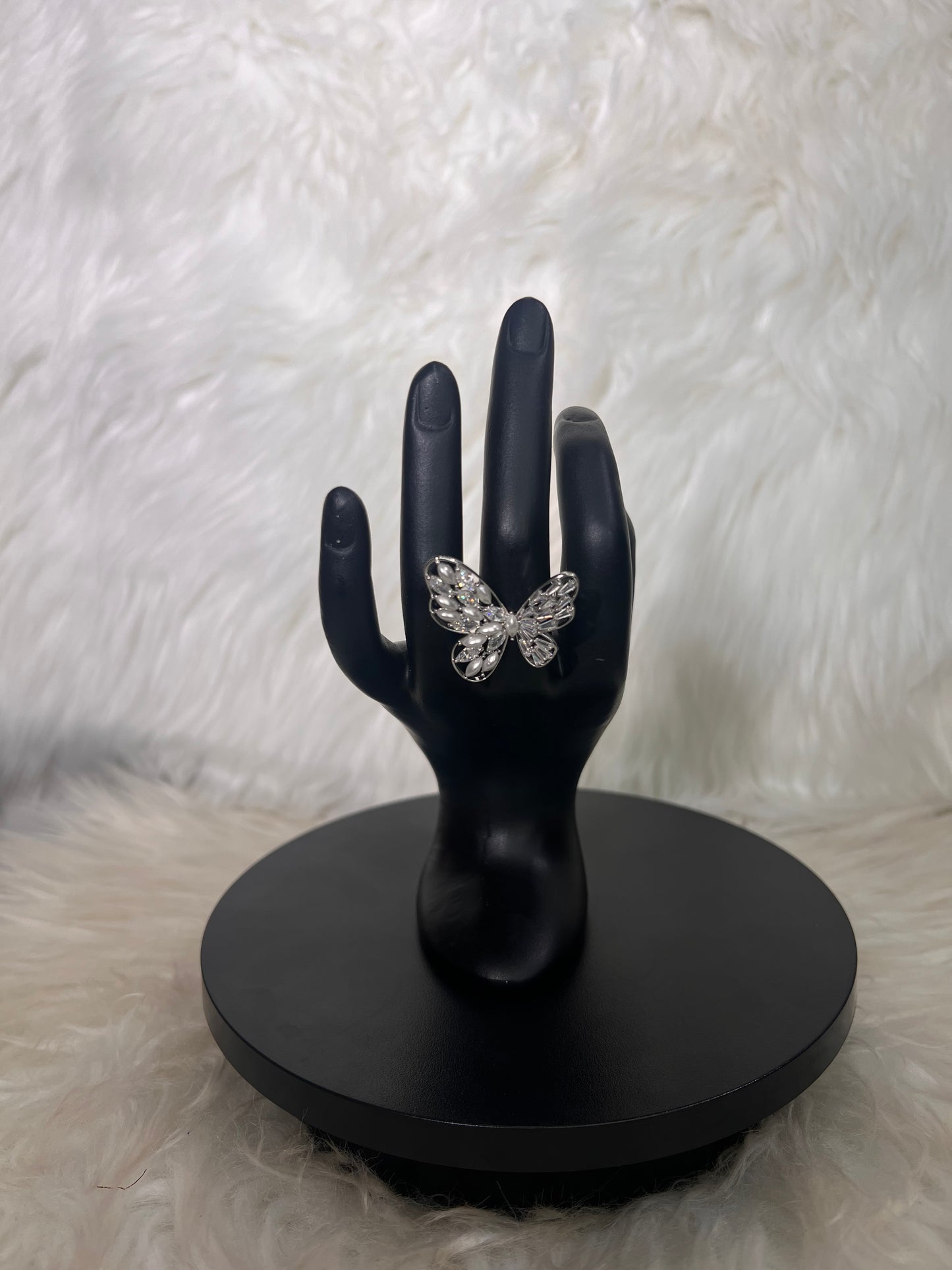 Features an open-wing silhouette accented by mixed round and marquise-cut crystal clusters.