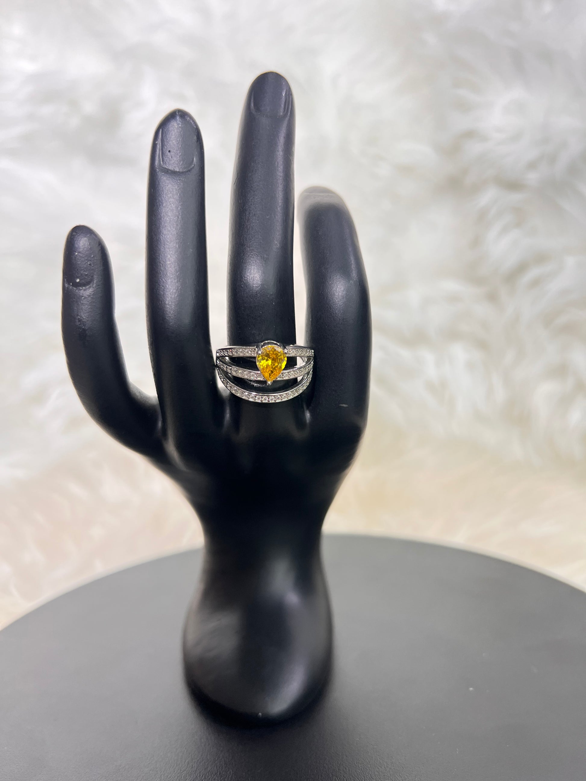 The open architectural lines of the triple bands are delicately lined with pavé crystals, effortlessly creating the illusion of stacked luxury rings in one singular, breathtaking piece.