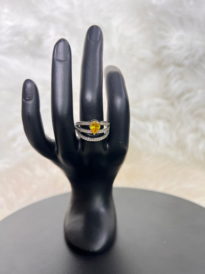 The open architectural lines of the triple bands are delicately lined with pavé crystals, effortlessly creating the illusion of stacked luxury rings in one singular, breathtaking piece.