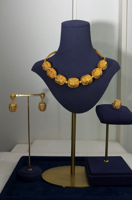 Finished with matching vertical barrel drop earrings and an identical statement cage ring, this suite brings a clean, rhythmic pattern to luxury accessorizing.