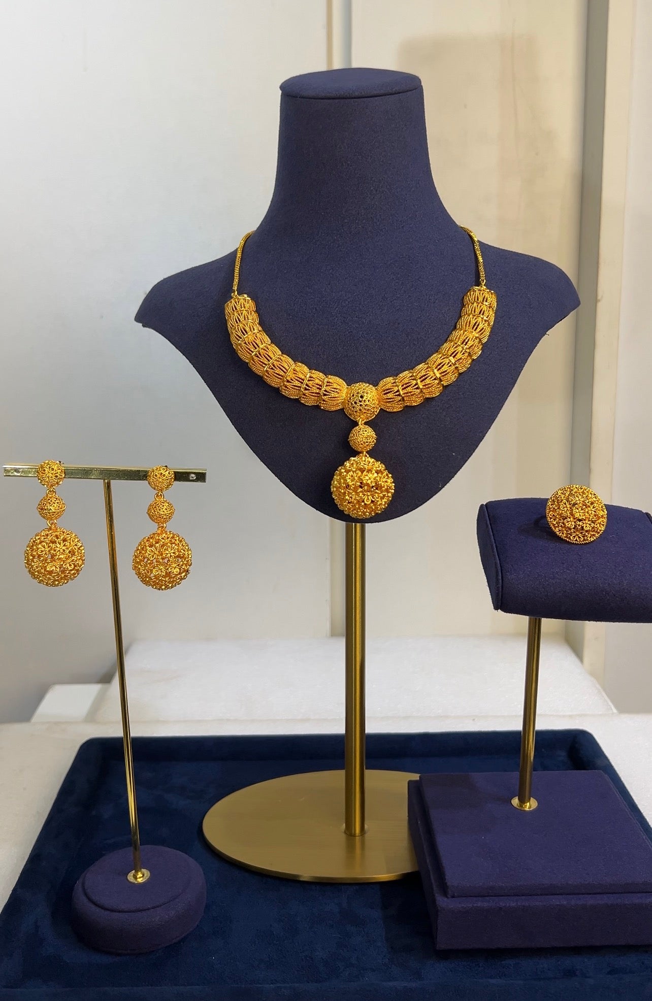 The matching triple-tier orb earrings and an expansive, matching filigree cocktail ring complete this regal ensemble, making it an ideal heirloom piece for special festive and bridal occasions.