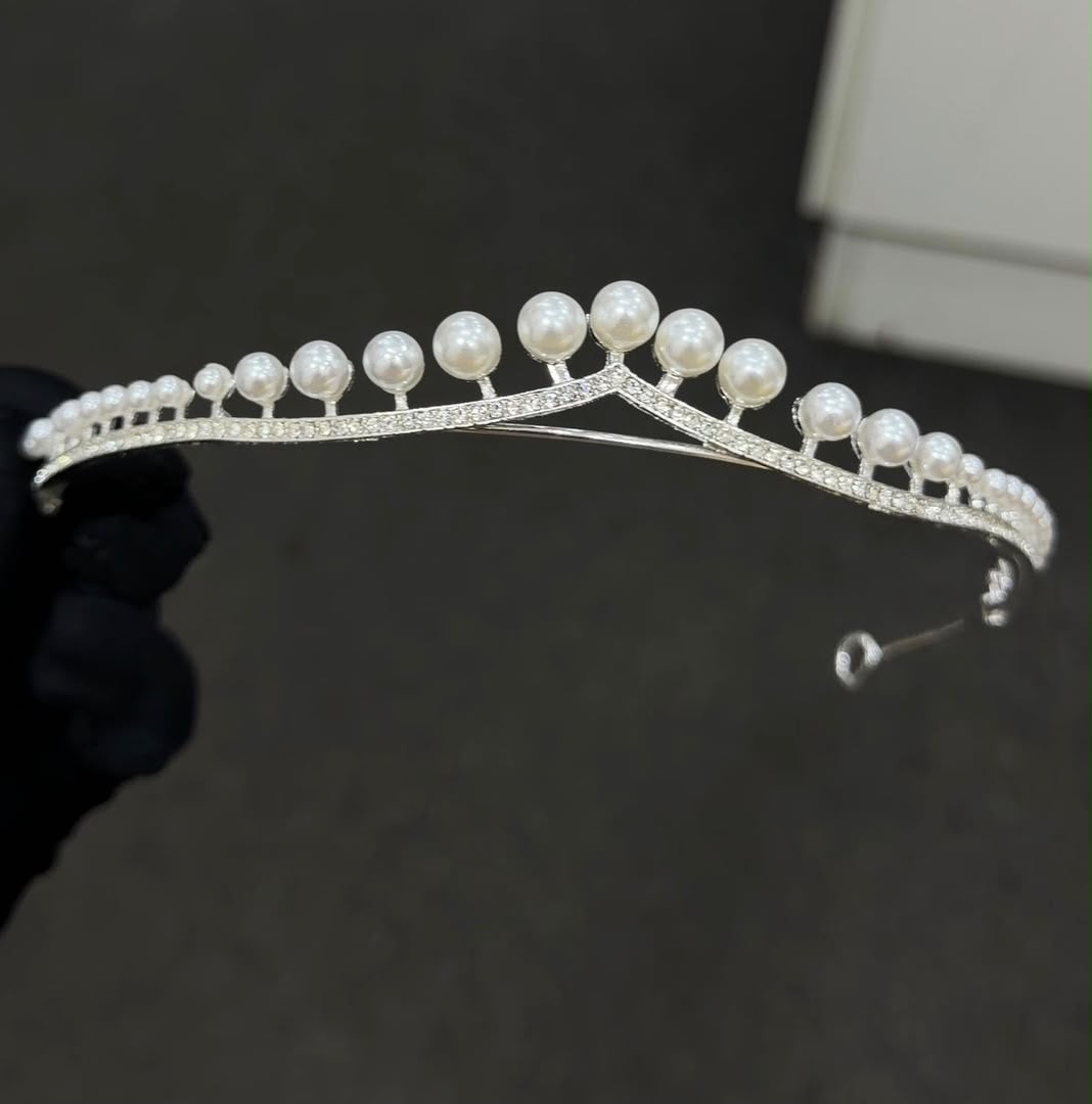 A silver tiara headband decorated with white pearls and clear rhinestones, 
