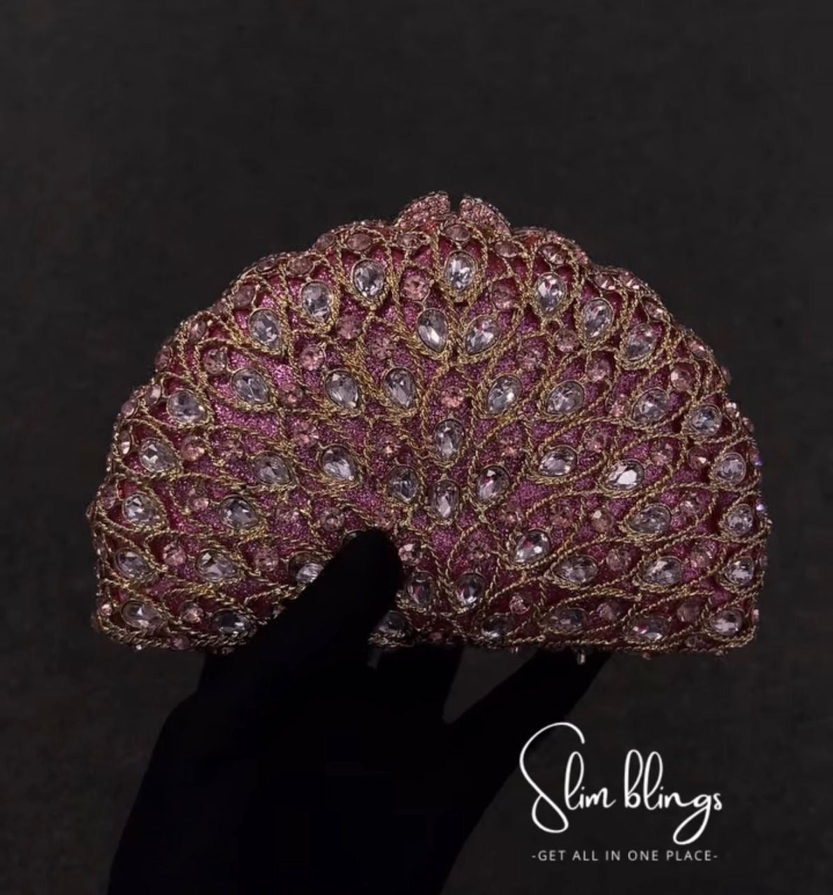 Decorative Clutch with pink and gold embellishments ,it draws inspiration from the graceful beauty of a peacock feather and a blooming flower